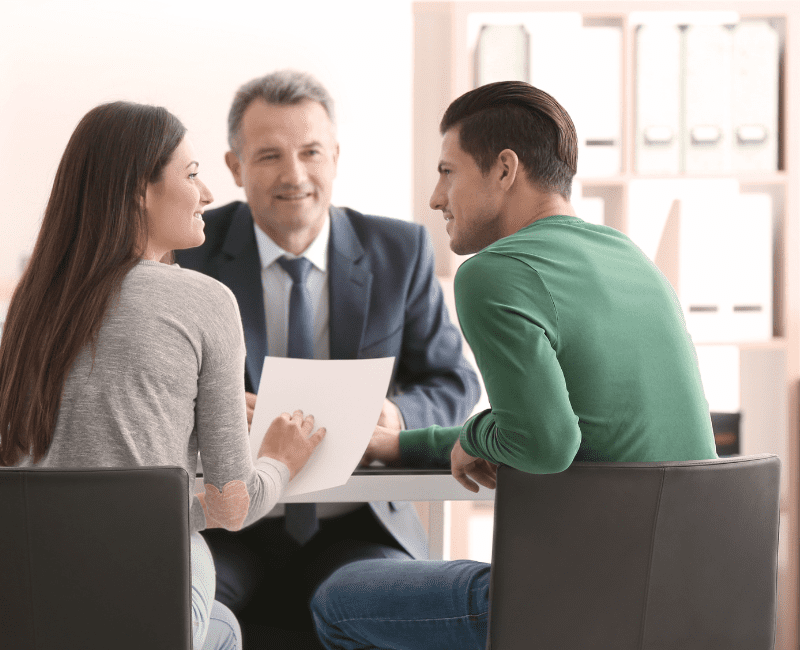 Young couple speaking with a public adjuster